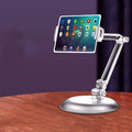 White adjustable phone/tablet stand with clamp, holding a tablet on a base