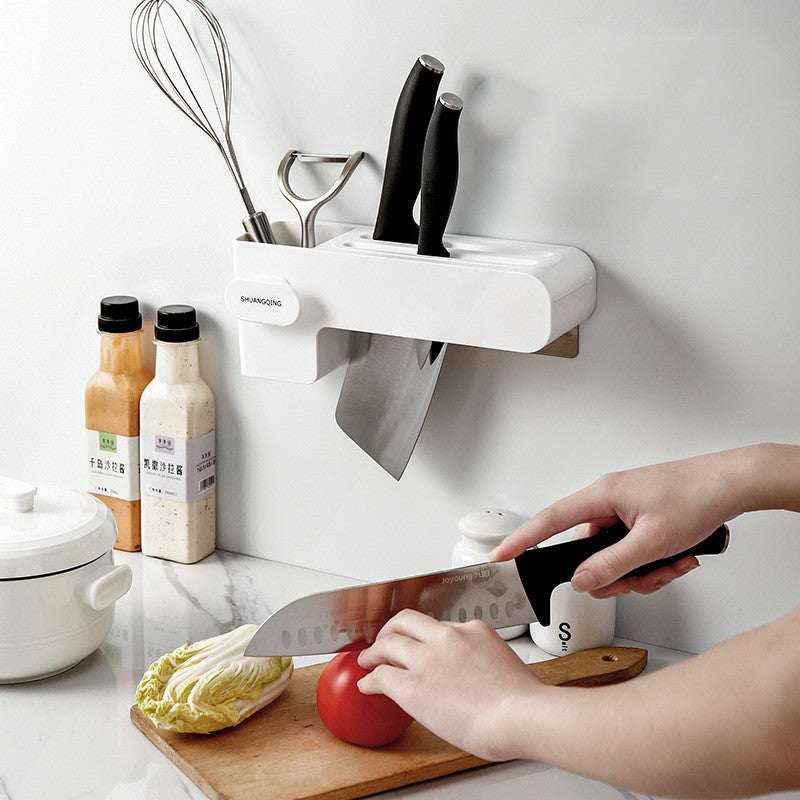 White kitchen knife rack with two slots and hanging knife, countertop accessory