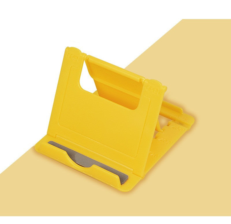 Yellow folding phone stand with angled cradle and wide anti-slip base