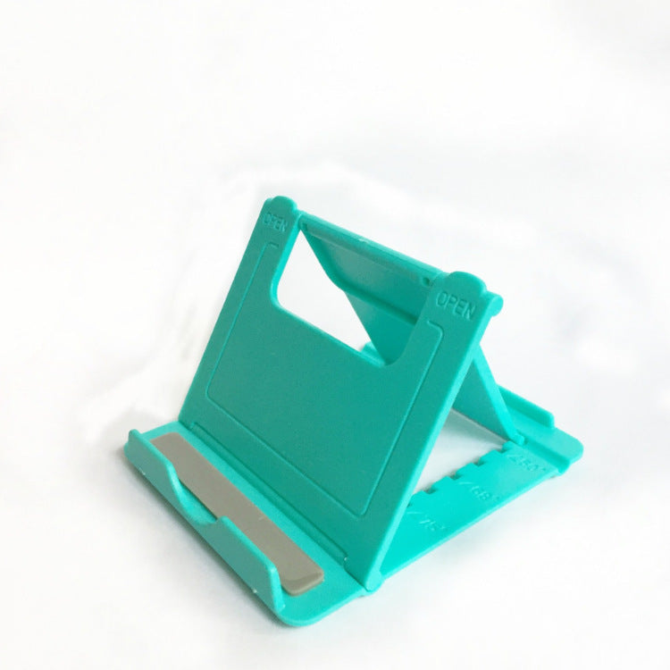 Green folding phone stand with wide base and angled cradle