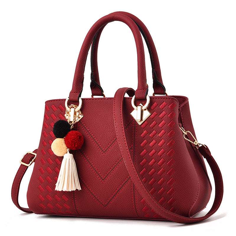 Wine red quilted crossbody handbag with tassel pom and gold-tone hardware