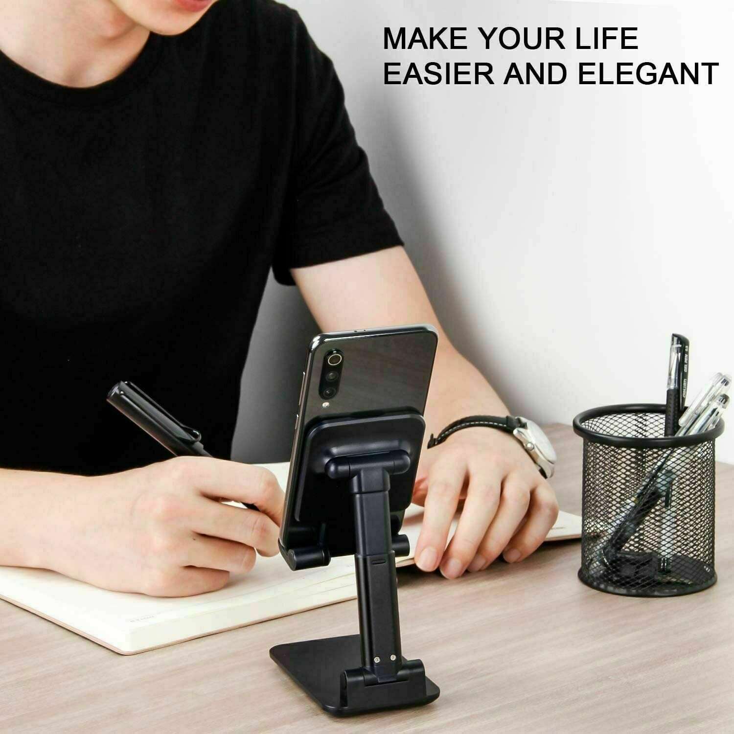 Black desktop phone stand holding a phone on a desk at an angle