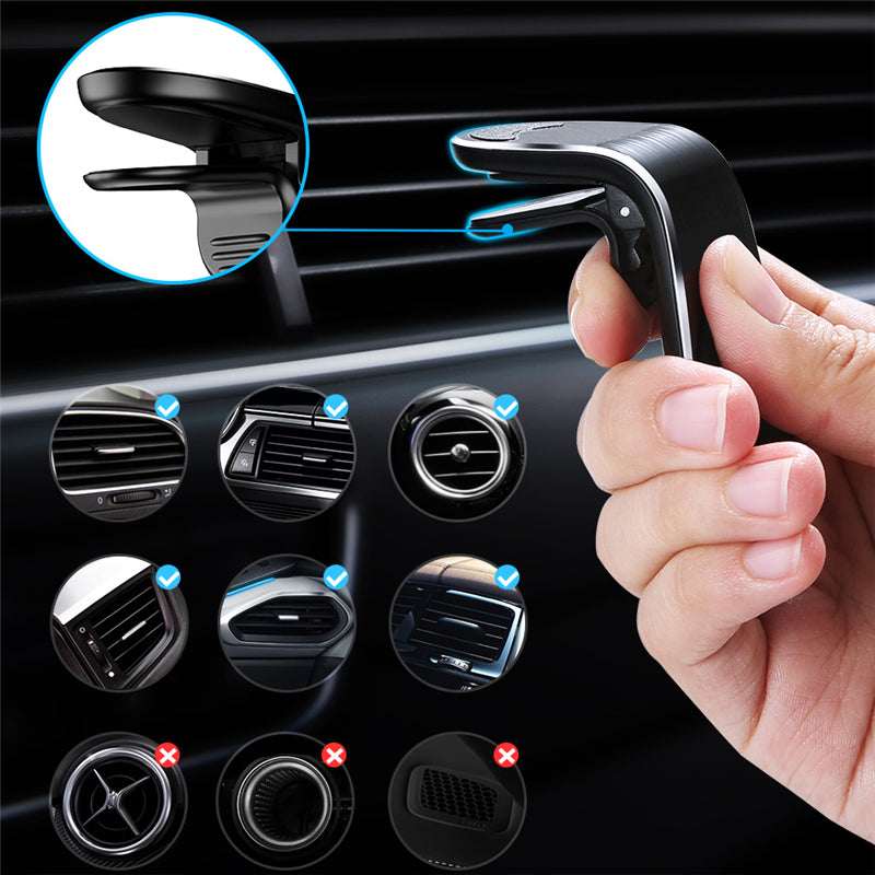 Black magnetic phone vent mount with spring clip, held by hand near car vent