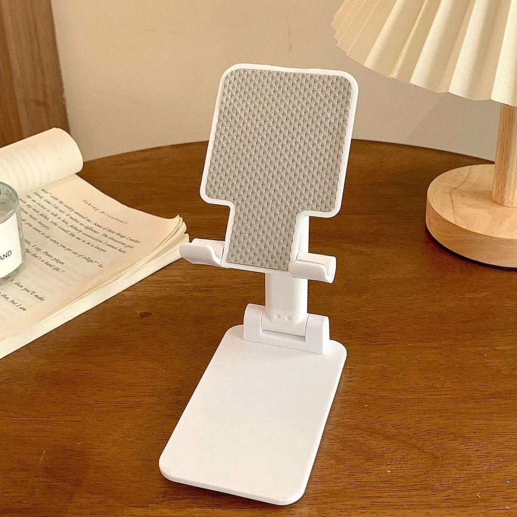 Folding mobile phone stand, white base with textured back panel and angled support