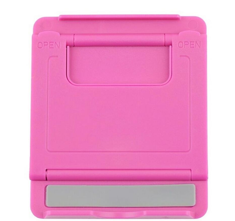 Foldable plastic tablet stand in pink with open cradle and support base