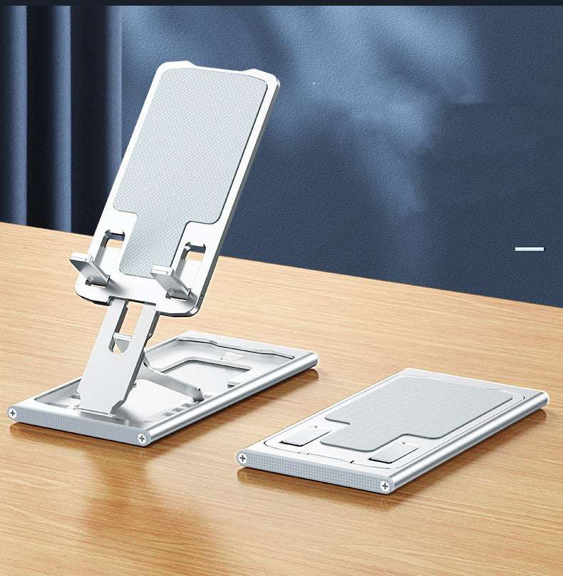 Foldable mobile phone stand with upright cradle and fold-flat support base
