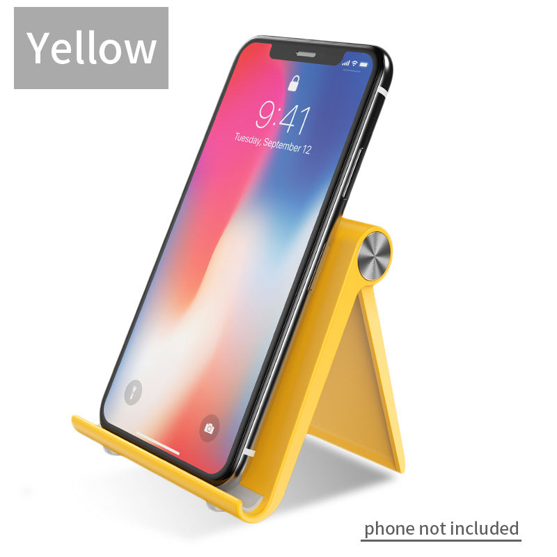 Yellow desktop phone stand with angled legs and circular knob, holding a smartphone