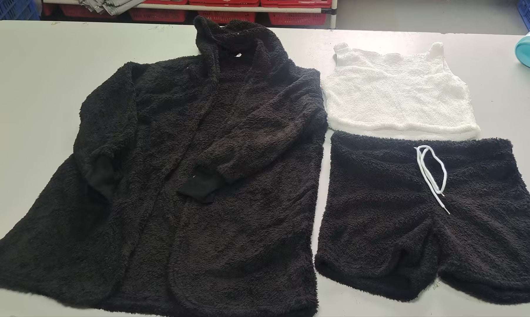 Fuzzy black lounge set with long-sleeve hooded top and drawstring shorts