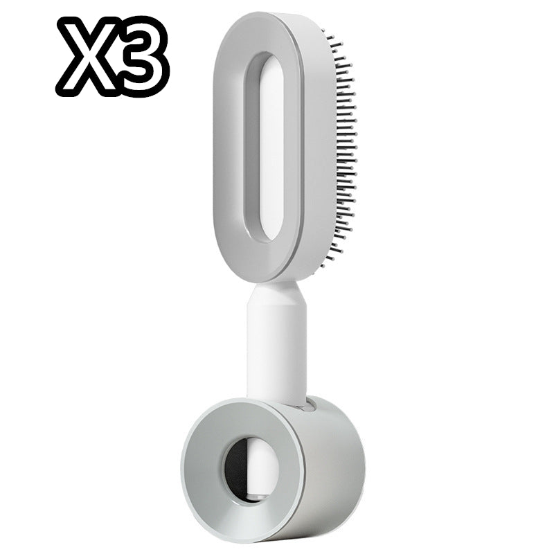 Self-cleaning hair brush with oval bristle pad, gray base and white handle