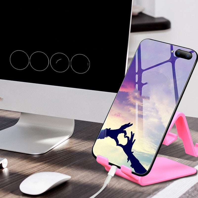 Pink universal phone and tablet stand holding a smartphone in an angled cradle