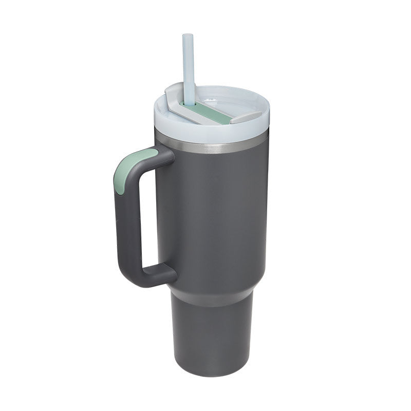Gray insulated travel tumbler with green handle, lid, and clear straw