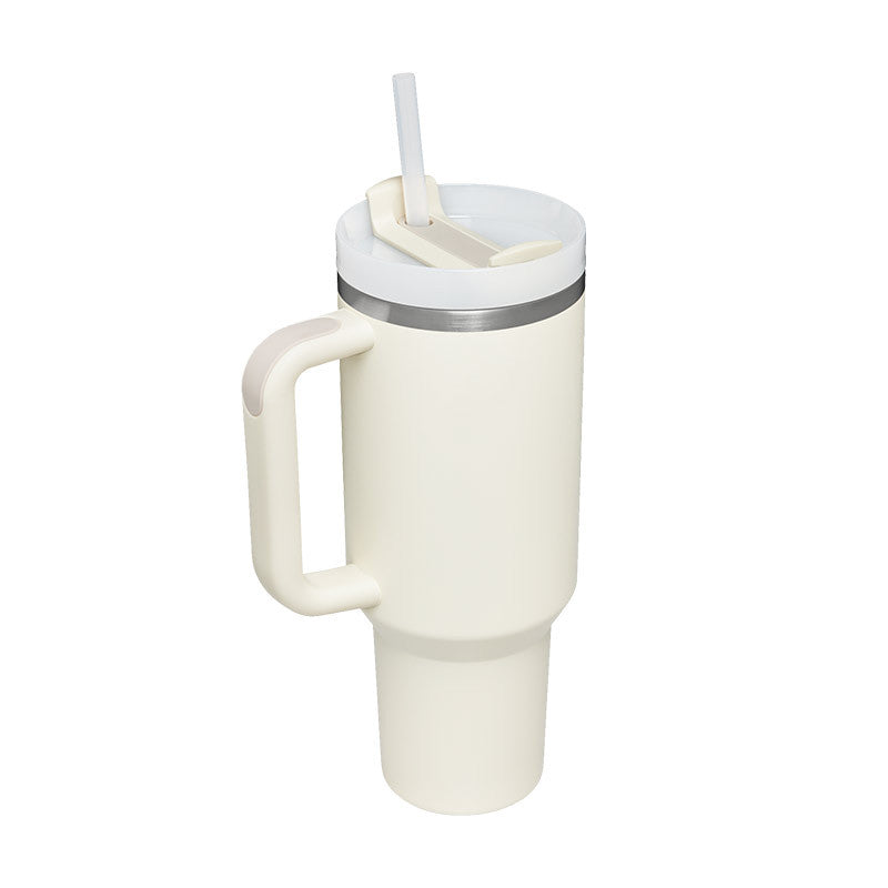 Cream insulated travel tumbler with handle, lid, and clear straw