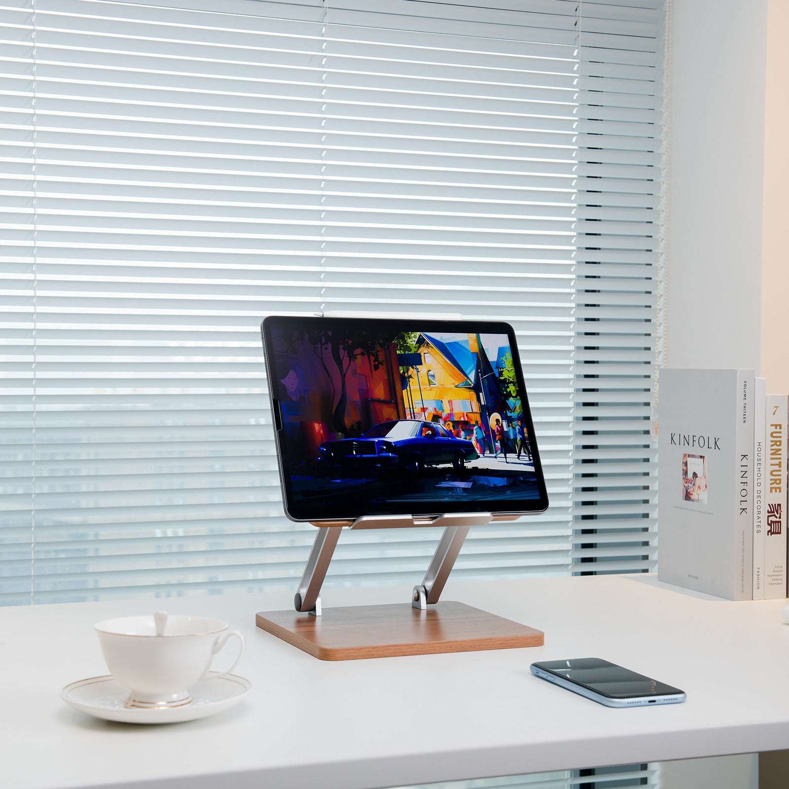 Mobile phone stand on dark wood base with silver legs, tablet held upright