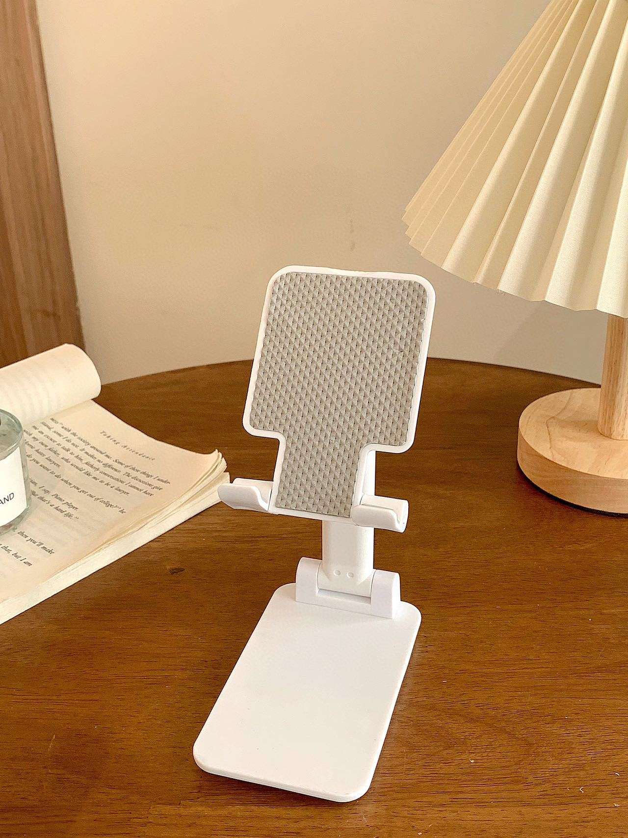 Folding mobile phone stand, white base with textured back panel and angled support