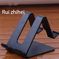 Navy blue universal phone and tablet stand with angled cradle and side support