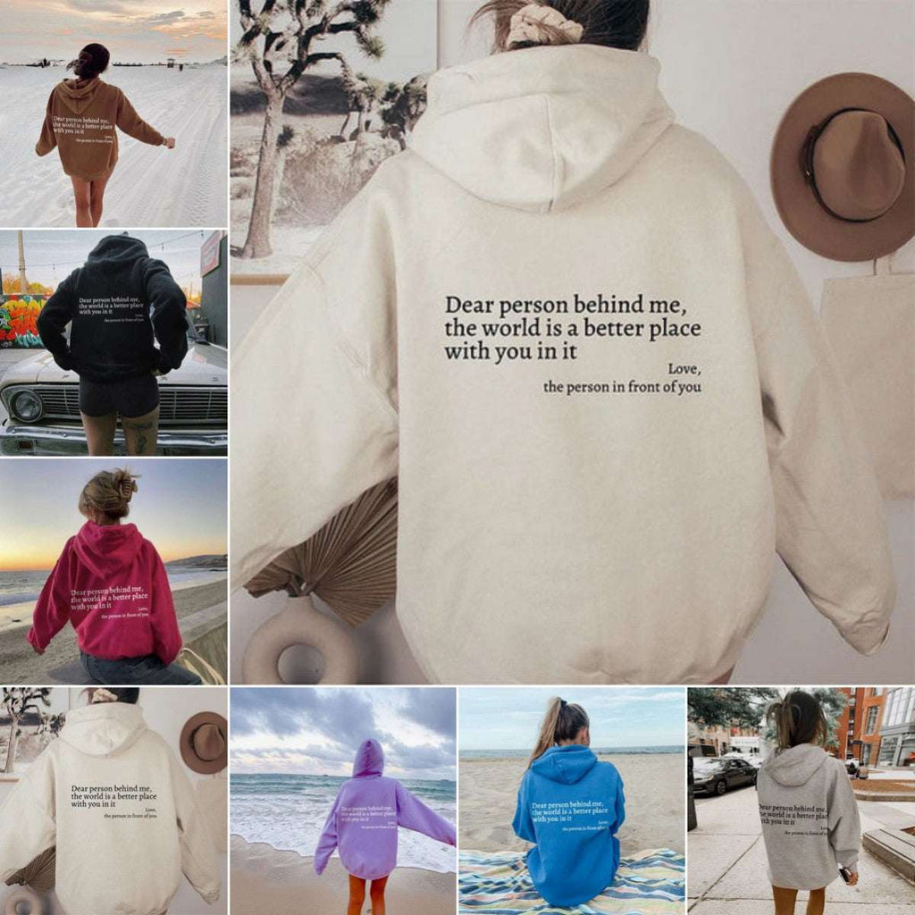 Cream plush hoodie with drawstring hood, kangaroo pocket, and letter graphic on back