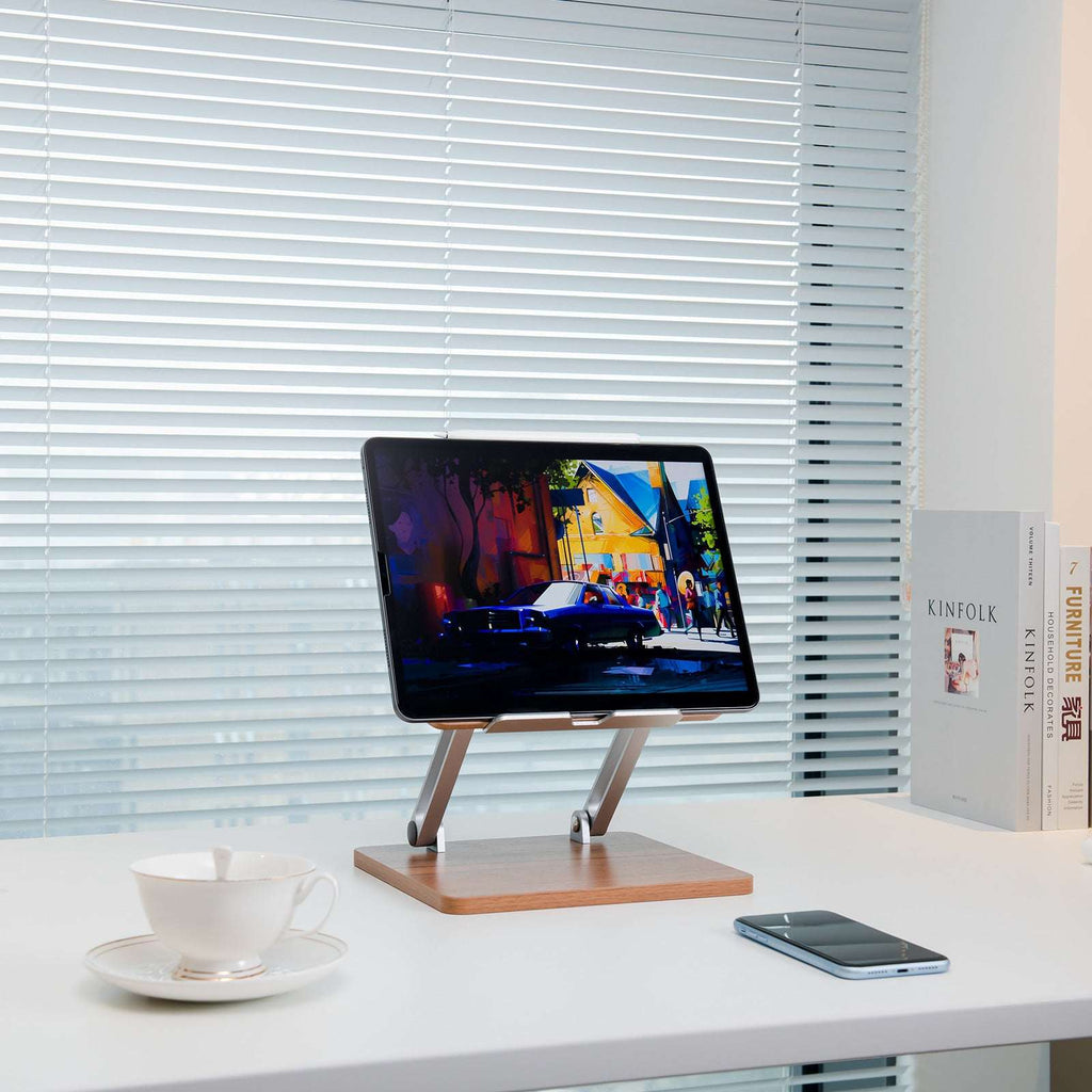 Desktop phone stand with dark wood platform and silver legs, tablet on stand