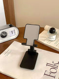 Folding mobile phone stand, dark/black base with textured back panel and angled grip