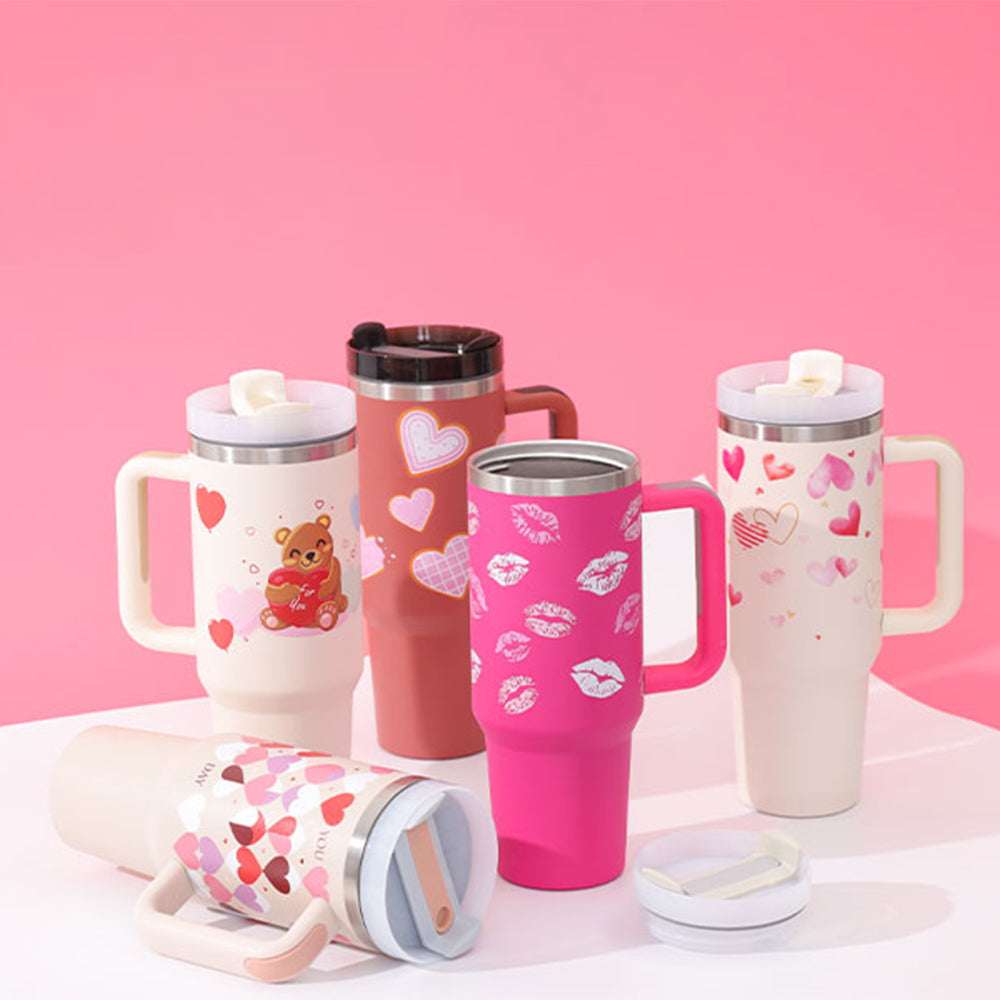 Insulated tumblers with handles and straws, pink, red, and cream with heart patterns