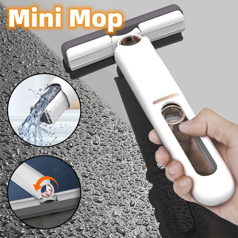 Mini sponge squeeze mop with white handle and gray squeegee head, held in hand
