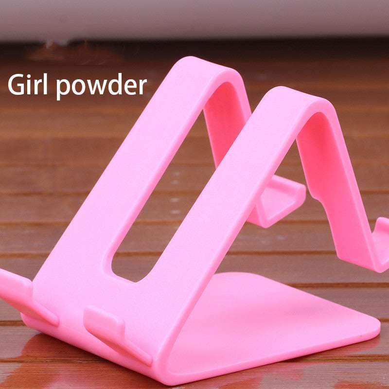 Pink universal phone and tablet stand with angled cradle and side grip tabs
