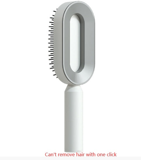 Self-cleaning hair brush with grey bristle head and white handle